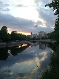 Scenic view of lake against sky at sunset