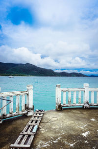 View of boats in sea against cloudy sky