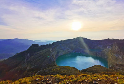 Scenic view of waterfall against sky during sunset