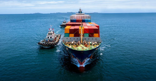 Ship sailing in sea against sky