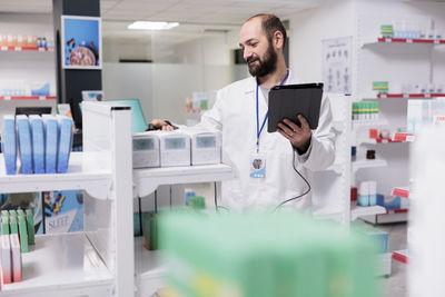 Portrait of female doctor examining chemical in laboratory