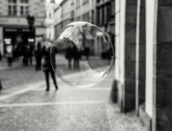 Bubble floating over street in city