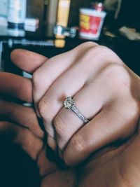 Close-up of couple holding hands in cafe