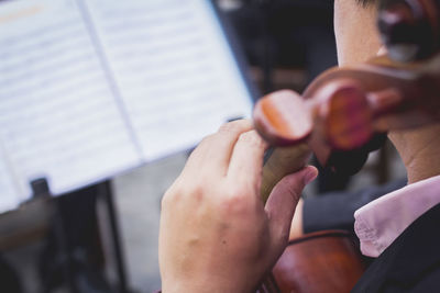 Cropped image of man playing musical instrument