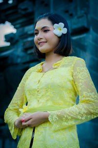 Young woman with yellow hair standing outdoors