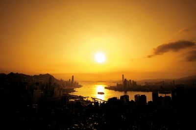 City at victoria harbour against orange sky