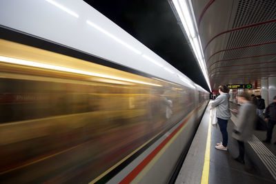 Blurred motion of train at railroad station