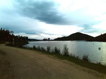 Scenic view of lake against cloudy sky