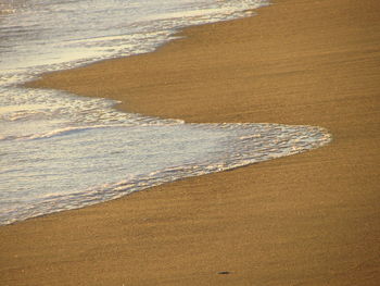 High angle view of waves on shore