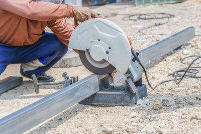 Low section of man working at workshop