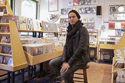 Portrait of smiling young woman standing in store