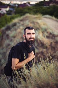 Portrait of a man with a beard on the background of nature and mountains