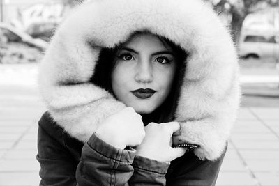 Portrait of woman standing in fur coat