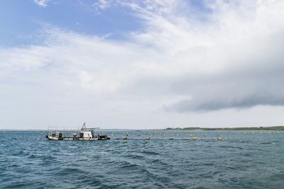 Boat sailing in sea against sky