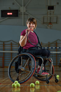 Side view of young woman sitting on wheelchair