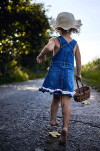 Full length rear view of woman walking in basket