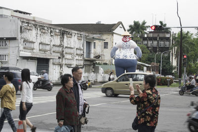 People on road in city