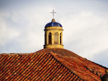 Low angle view of bell tower against sky