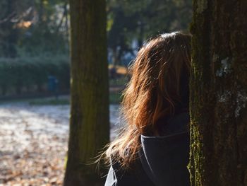 Rear view of woman by tree at park