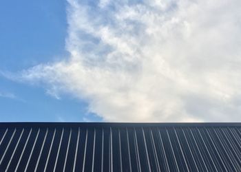 Low angle view of metallic structure against sky