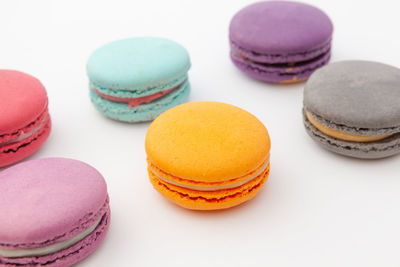 Close-up of multi colored candies against white background