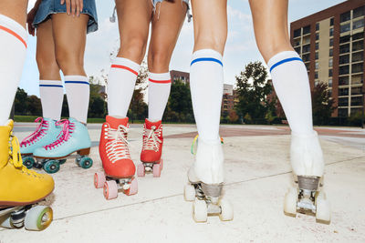 Legs of women wearing roller skates at sports court