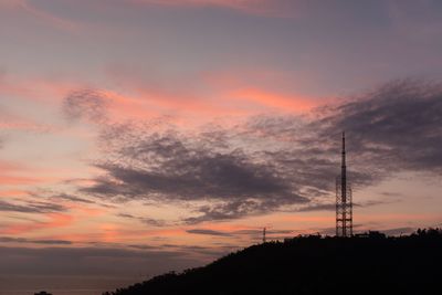 Low angle view of silhouette tower against sky during sunset