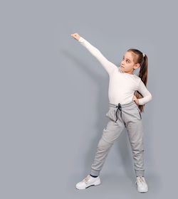 Determined, cool little girl raised her hands. little girl shows fighting techniques.