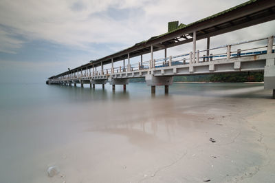 Bridge over sea against sky