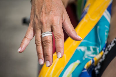 Midsection of woman with hand after nailcare