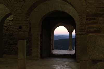 Archway of historic building against sky