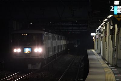 Illuminated railroad station platform at night