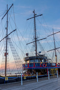Sailboats moored in sea against sky