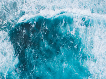 High angle view of waves in blue sea water