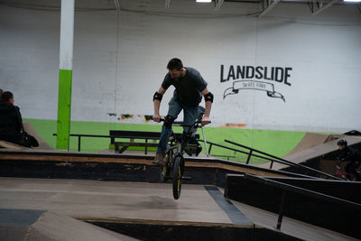 Man with bicycle on railing