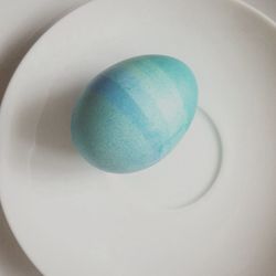 High angle view of multi colored eggs on white background