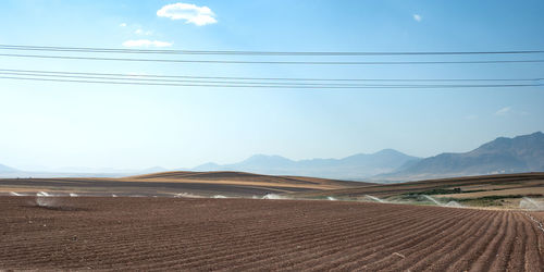 Scenic view of arid landscape against sky