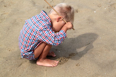 High angle view of boy playing on beach