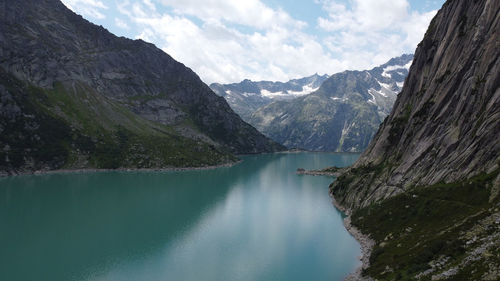 Scenic view of lake amidst mountains against sky