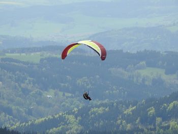 Person paragliding against sky