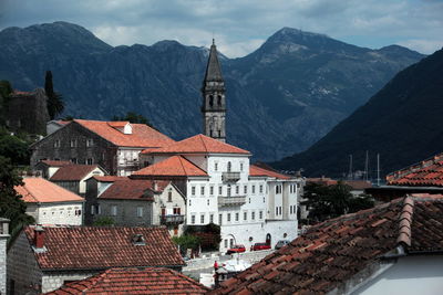 Houses on coast with mountain range in background