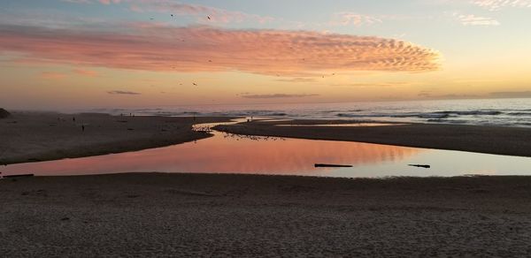 Scenic view of sea against romantic sky at sunset