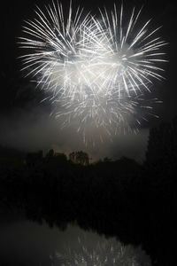 Low angle view of firework display at night