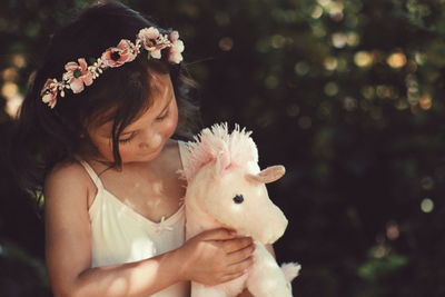 Young woman holding rabbit on flower