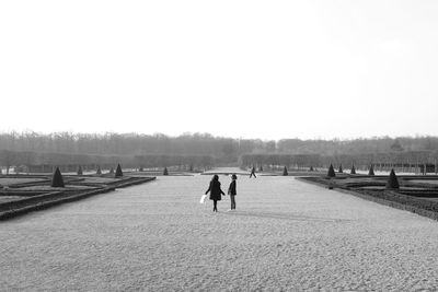 Man on snowy field against clear sky