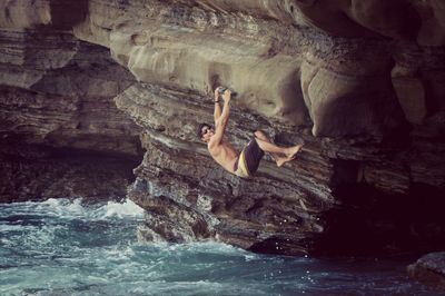 People on rocks in water