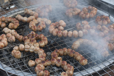 High angle view of meat on barbecue grill