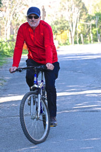 Man riding bicycle on road