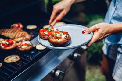 Man preparing food on barbecue grill