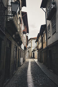 Narrow alley amidst buildings in city